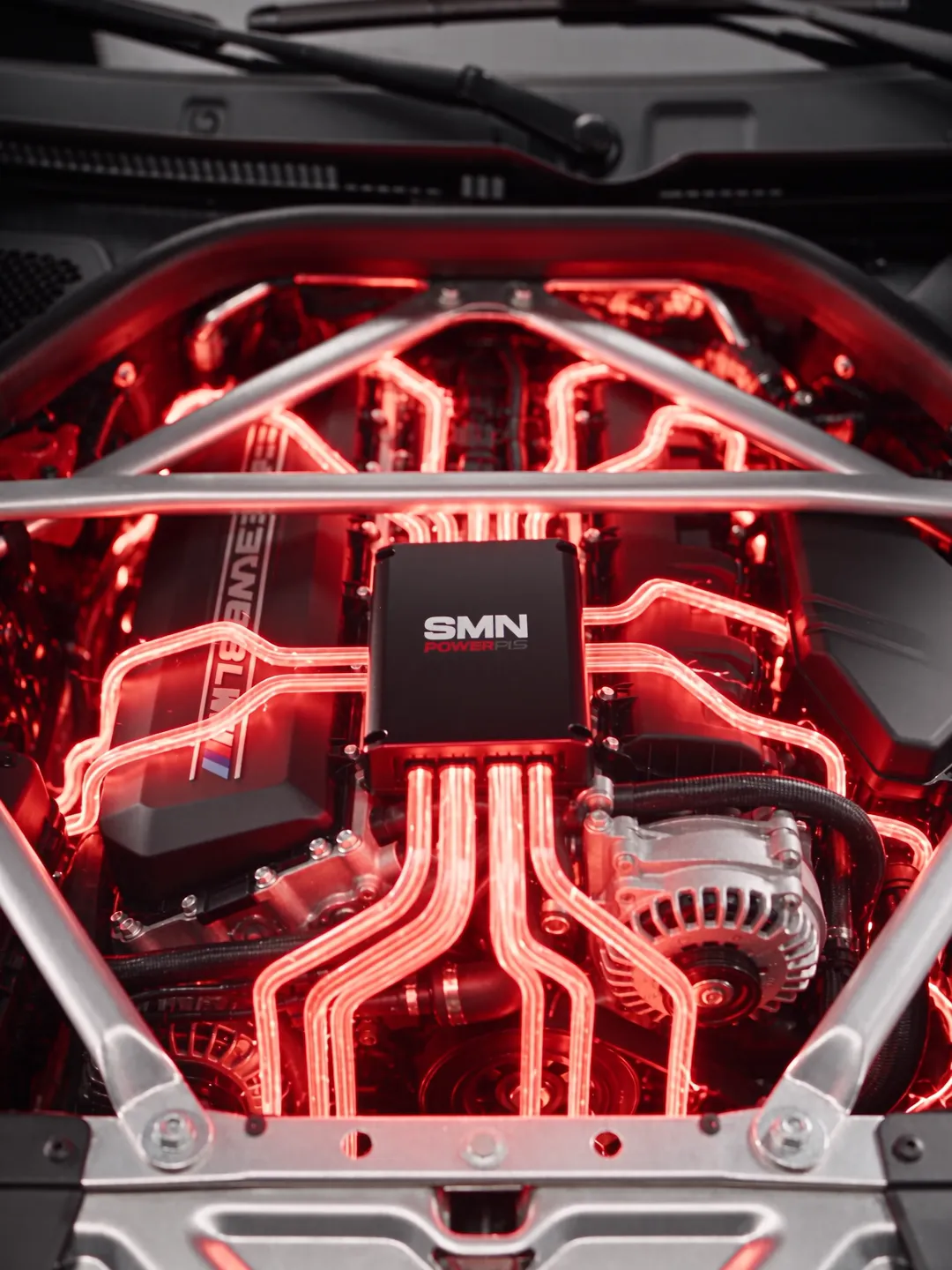The bonnet of a BMW M4 opens and the SMN Power Pack is fitted in the engine bay